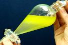 Lab Extraction Being Carried Out on a Yellow Fluid in a Separatory Funnel